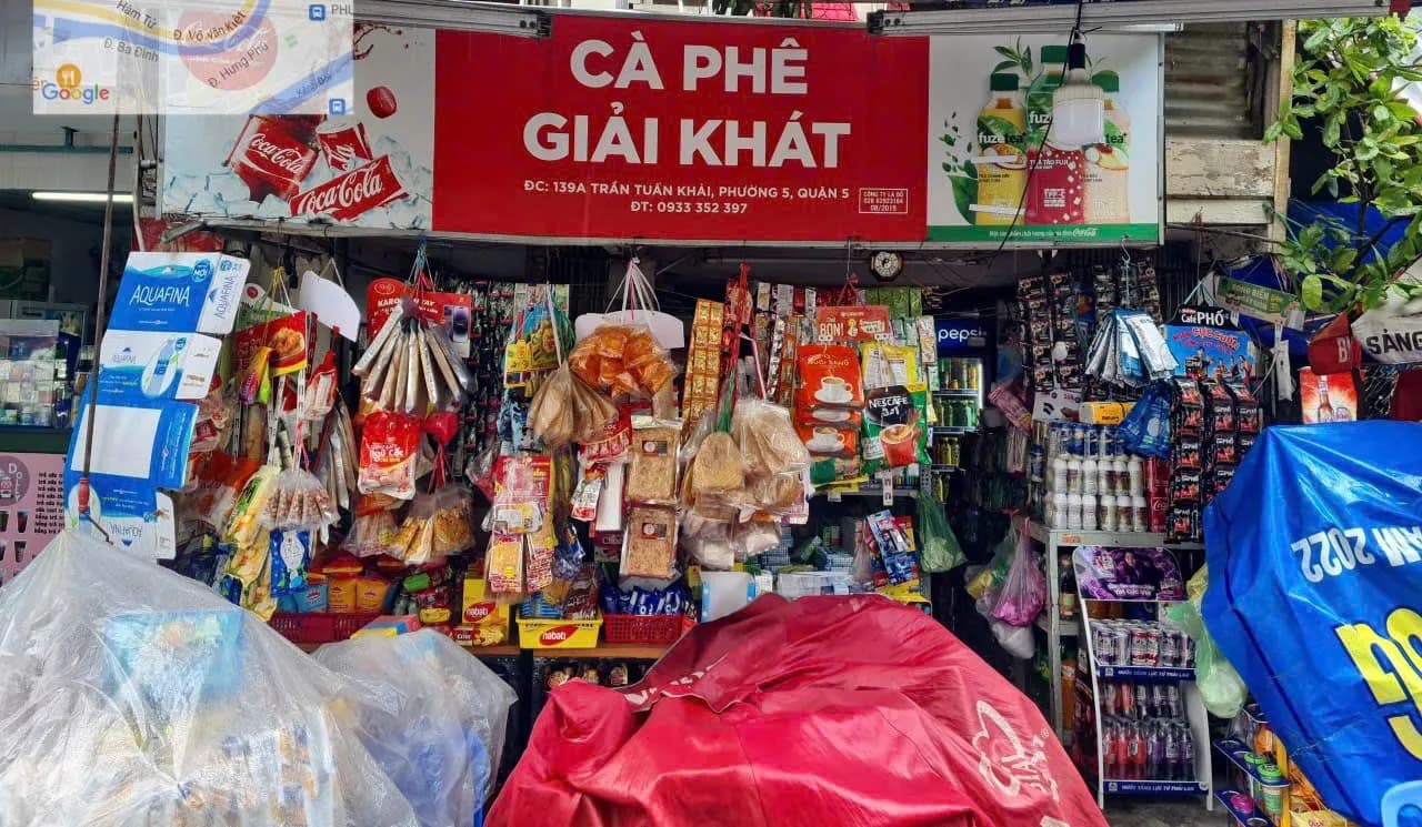 A traditional tap hoa grocery store stocked with packaged goods.