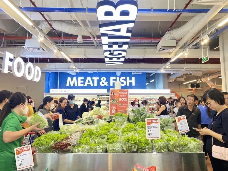 Shoppers in a modern-trade supermarket aisle.