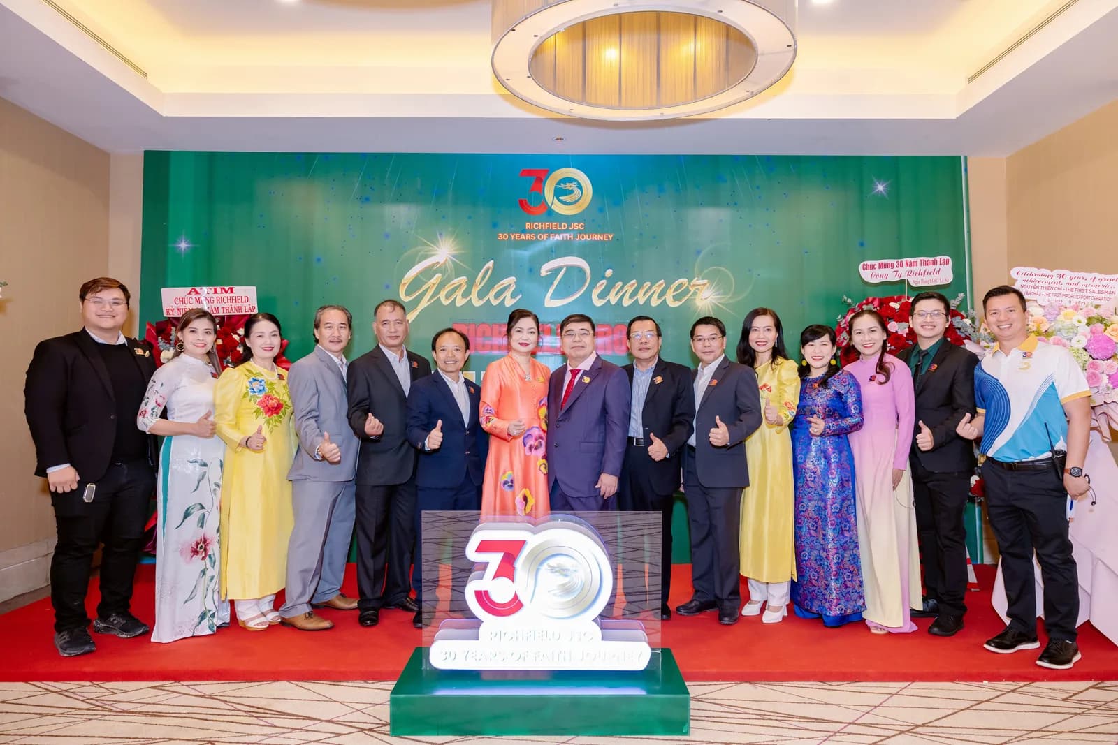 Richfield 30-year Gala Dinner — leadership lineup in front of the anniversary backdrop
