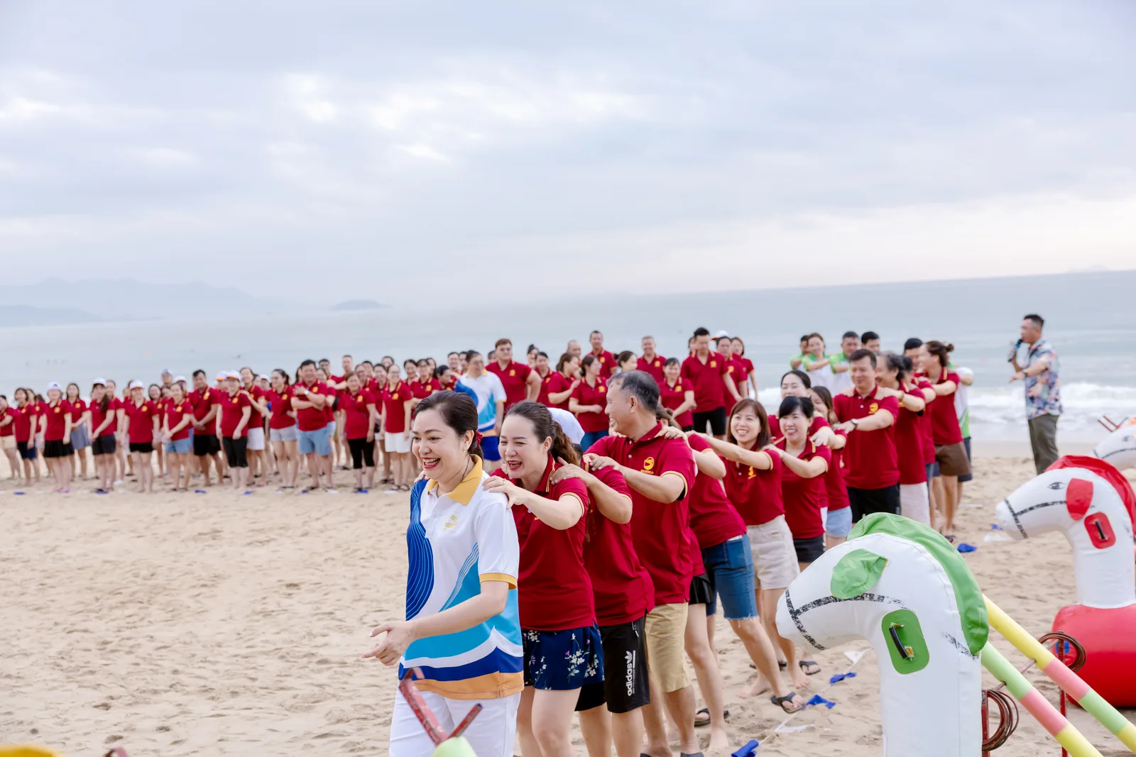 The Richfield team in a conga line on the beach